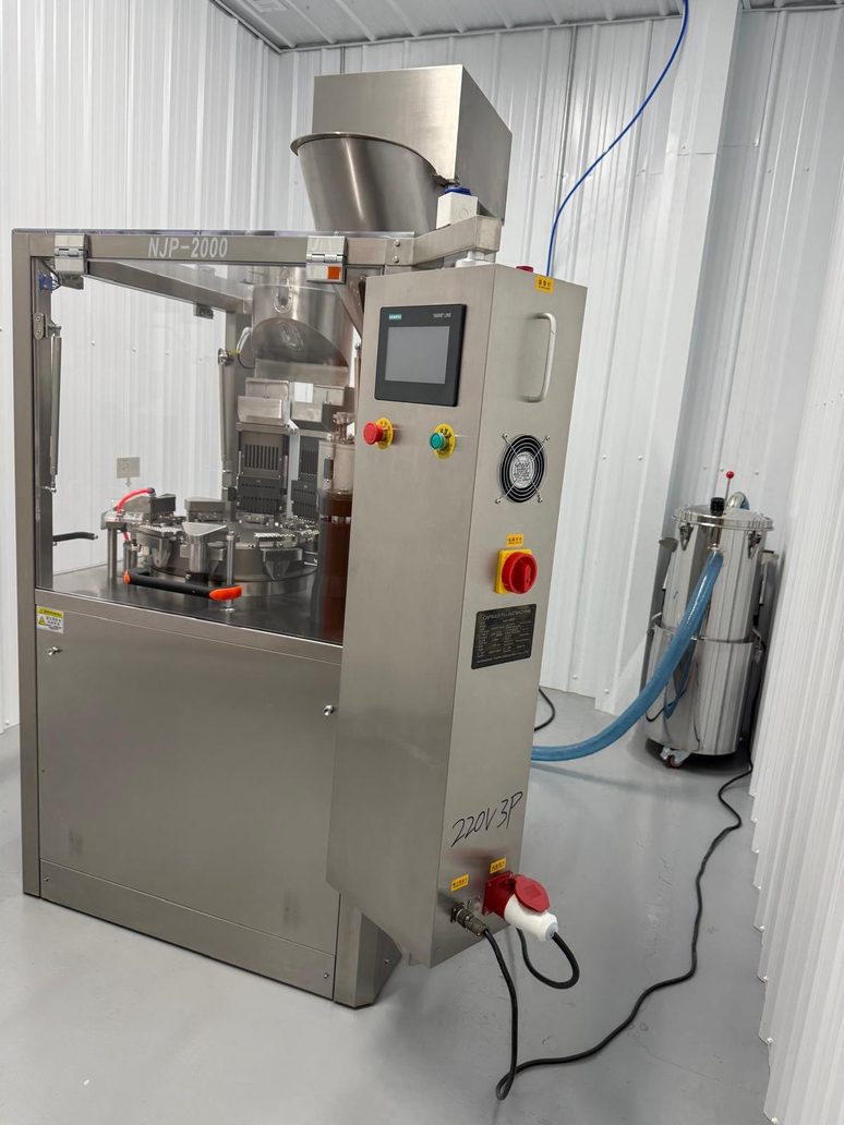 The NJP-2000 encapsulator with its dust collector standing beside it